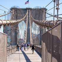 Pedestrians walking across the Brooklyn Bridge in New York City