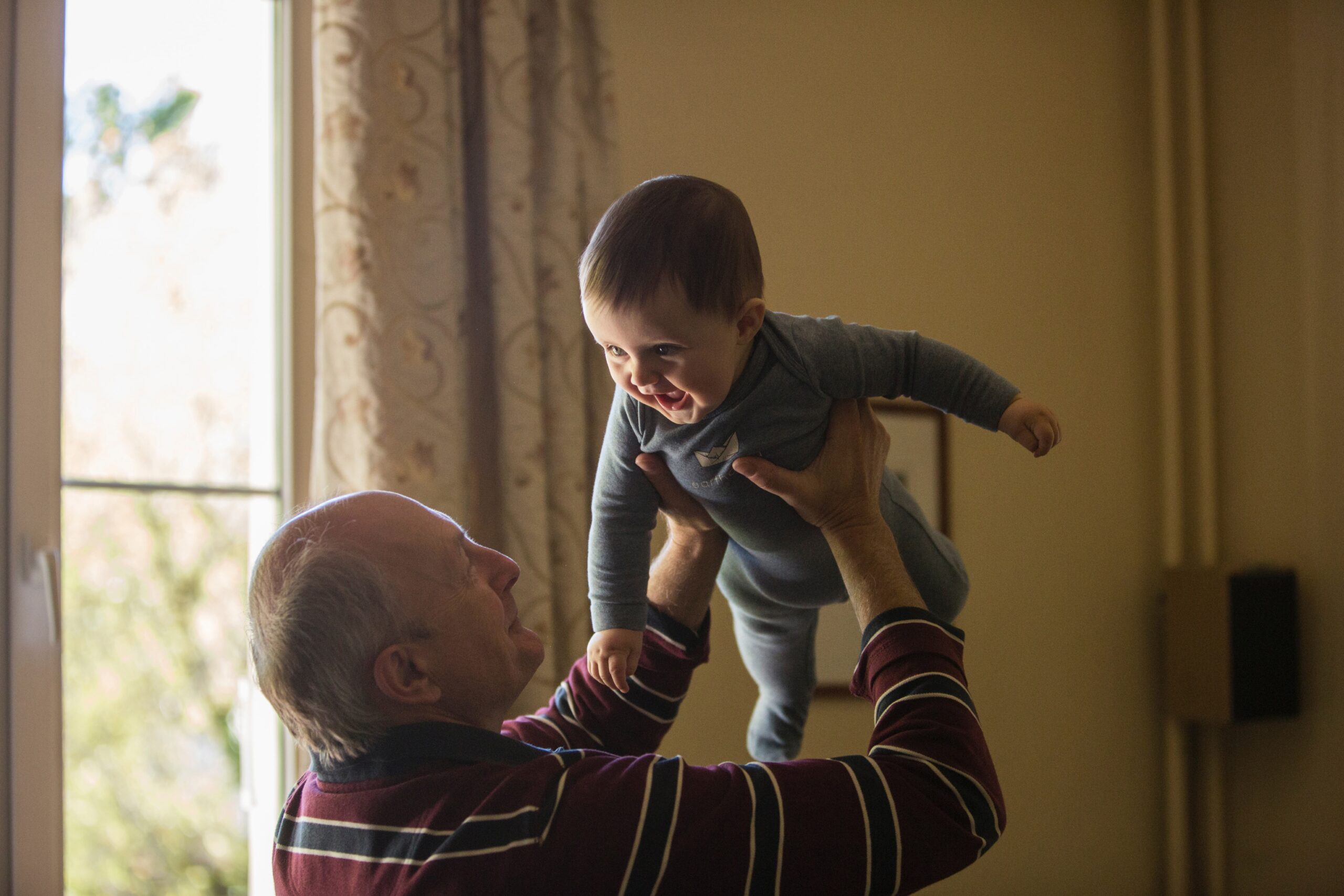 Older generation playing with younger generation in a comfortable family setting